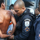 A suspect is handcuffed by military police during a joint operation including the CORE police special forces near the Complexo do Alemao pacified community, or “favela,” on May 13, 2014, in Rio de Janeiro.
Mario Tama/Getty Images